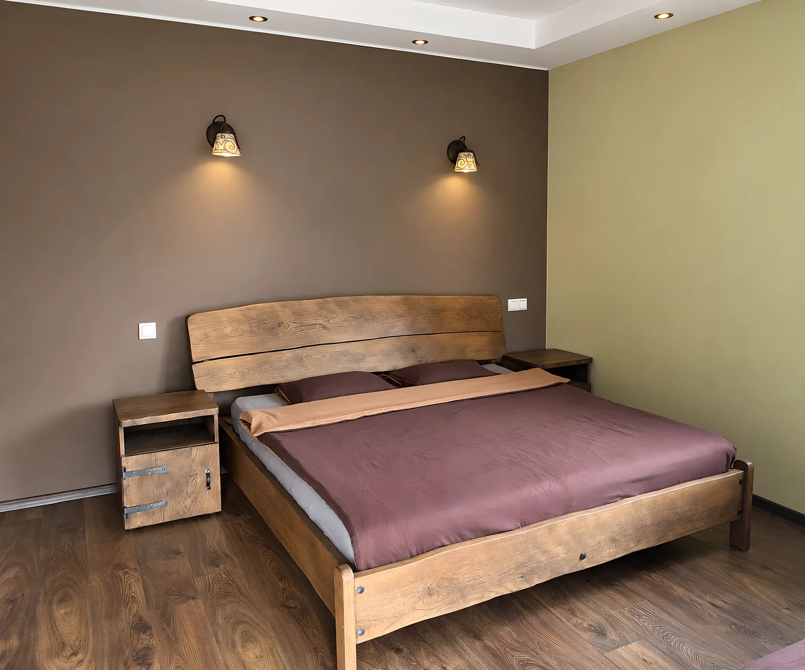 A bedroom with a wooden bed and a dark brown wall