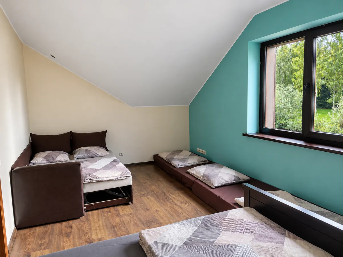 A bedroom looking out over the birch wood